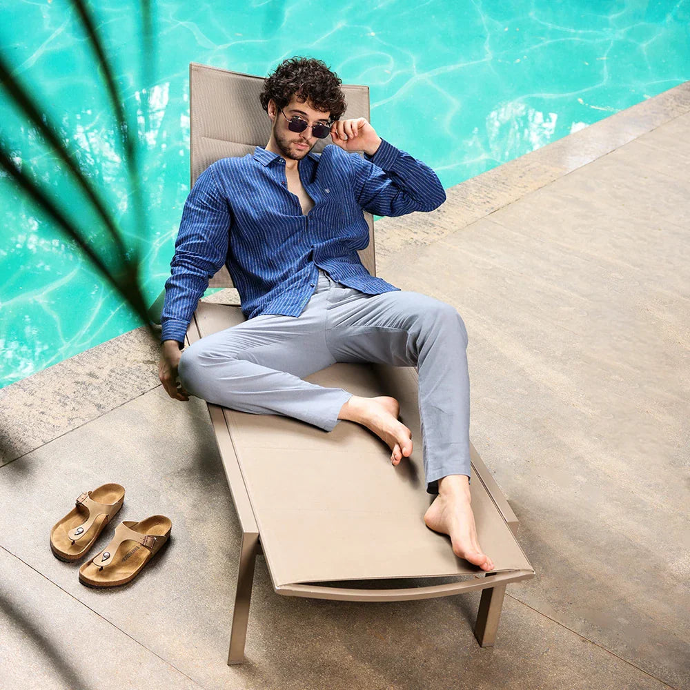 A man effortlessly dressed in breathable, lightweight summer essentials—staying cool and sharp in the heat.