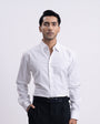 Man wearing a white dress shirt and black pants on a white background