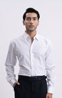 Man wearing a white dress shirt and black pants on a white background