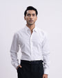 Man wearing a white dress shirt and black pants on a white background